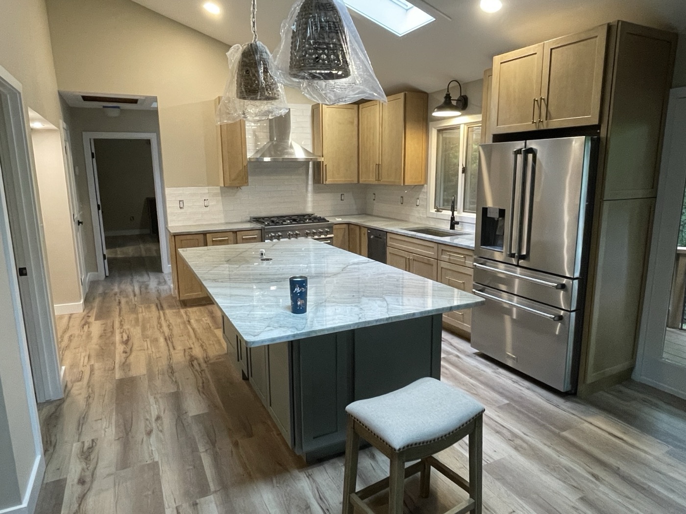 Kitchen with a stone-topped island and stainless appliances