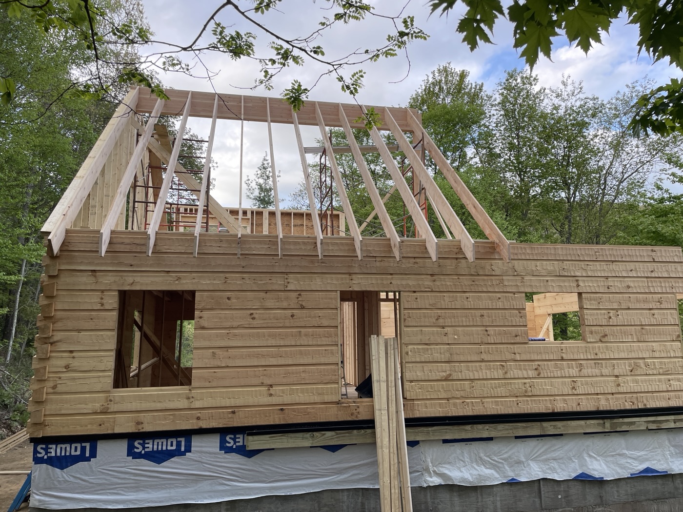 Log walls and rafters going up on a new build